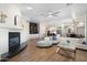 Open concept living room featuring a fireplace, comfortable seating and an expansive area that flows into the kitchen at 27606 N 61St Pl, Scottsdale, AZ 85266