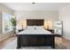 This main bedroom features a king bed, neutral walls, wood floors and decorative lamps at 27606 N 61St Pl, Scottsdale, AZ 85266