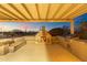 Outdoor kitchen area includes a built-in fireplace, a barbecue, and bar seating with a covered patio at 27606 N 61St Pl, Scottsdale, AZ 85266