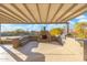 Spacious covered patio with fireplace, built-in grill, and ample seating at 27606 N 61St Pl, Scottsdale, AZ 85266