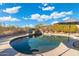 Inviting pool with ledge stone feature against beautiful desert landscape and blue skies at 27606 N 61St Pl, Scottsdale, AZ 85266