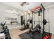 Bright workout room with modern exercise bike, weight rack, and mirrored wall at 27606 N 61St Pl, Scottsdale, AZ 85266