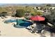 Aerial view of pool, patio, outdoor dining area, mature landscaping and mountain views at 27701 N Lucero Dr, Rio Verde, AZ 85263