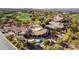 Aerial view of a backyard featuring a covered patio, a pool, and beautiful mature trees at 27701 N Lucero Dr, Rio Verde, AZ 85263