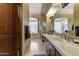 A luxurious bathroom featuring dual sinks, a soaking tub, and travertine tile flooring at 27701 N Lucero Dr, Rio Verde, AZ 85263