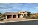 Southwestern-style home with tile roof and a spacious two-car garage and well-maintained landscaping at 27701 N Lucero Dr, Rio Verde, AZ 85263