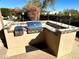 Built-in outdoor kitchen with stainless steel grill and tile countertops at 27701 N Lucero Dr, Rio Verde, AZ 85263