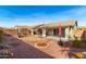 A desert landscaped backyard including an outdoor kitchen, patio, and desert plants at 30124 N Sunray Dr, San Tan Valley, AZ 85143