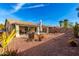 A desert landscaped backyard includes an outdoor kitchen, patio, and desert plants at 30124 N Sunray Dr, San Tan Valley, AZ 85143