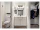 This bathroom features a toilet, single sink vanity, and framed mirror at 30124 N Sunray Dr, San Tan Valley, AZ 85143