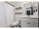 This bathroom features a toilet, single sink vanity, and framed mirror at 30124 N Sunray Dr, San Tan Valley, AZ 85143