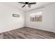 This unfurnished bedroom features a ceiling fan, plank flooring and neutral paint at 30124 N Sunray Dr, San Tan Valley, AZ 85143