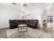 Comfortable living room with a large leather sofa and round coffee table at 30124 N Sunray Dr, San Tan Valley, AZ 85143