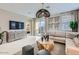 Bright living room with a modern sectional sofa, decorative lighting, and sliding doors to the backyard at 3266 E Baler Dr, San Tan Valley, AZ 85140