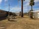 Backyard featuring sparse landscaping, a fountain, and an outdoor seating set under a blue sky at 3345 W Laurel Ln, Phoenix, AZ 85029