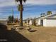 Backyard featuring sparse landscaping, a fountain, and an outdoor seating set under a blue sky at 3345 W Laurel Ln, Phoenix, AZ 85029