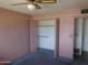 Bedroom with a closet, ceiling fan, blue carpet and light walls at 3345 W Laurel Ln, Phoenix, AZ 85029