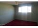 Bedroom with a window, ceiling fan, and red carpet at 3345 W Laurel Ln, Phoenix, AZ 85029