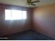 Bedroom with a window, ceiling fan, and dark carpet at 3345 W Laurel Ln, Phoenix, AZ 85029