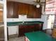 Kitchen featuring wood cabinets, stainless steel sink and bright green countertops at 3345 W Laurel Ln, Phoenix, AZ 85029