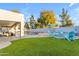 Resort-style backyard with lush turf, sparkling pool, spa and covered patio perfect for outdoor entertaining at 3459 E Mockingbird Dr, Gilbert, AZ 85234