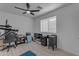 Bedroom with ceiling fan, large window, and desk at 3459 E Mockingbird Dr, Gilbert, AZ 85234