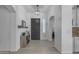 Inviting entryway featuring tile flooring, a stylish light fixture, and a charming console table, creating a warm and welcoming ambiance at 3459 E Mockingbird Dr, Gilbert, AZ 85234