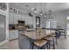 Modern kitchen featuring granite countertops, pendant lighting, a large center island with seating, and stainless appliances at 3459 E Mockingbird Dr, Gilbert, AZ 85234