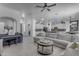 Expansive living room featuring tile floors, plush sectional sofa and seamless flow to the modern kitchen at 3459 E Mockingbird Dr, Gilbert, AZ 85234