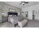 A well decorated main bedroom features a shiplap wall, accent chair, and bedside tables at 3459 E Mockingbird Dr, Gilbert, AZ 85234