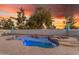 Backyard featuring a private pool with spa and an umbrella, surrounded by lush landscaping at 3459 E Mockingbird Dr, Gilbert, AZ 85234