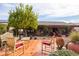 Spacious patio with red tiled floor, garden, potted plants and plenty of seating at 3648 N 162Nd Ave, Goodyear, AZ 85395