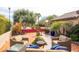 Beautiful backyard patio with cozy seating, lush plants, and tasteful landscaping at 3648 N 162Nd Ave, Goodyear, AZ 85395