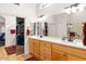 Bright bathroom with double sinks, a large mirror, and walk-in closets at 3648 N 162Nd Ave, Goodyear, AZ 85395