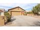 Home exterior with wide driveway, three-car garage, and manicured landscaping at 3648 N 162Nd Ave, Goodyear, AZ 85395