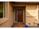 Inviting entryway with a solid wood door, decorative tile, and well-maintained landscaping at 3648 N 162Nd Ave, Goodyear, AZ 85395