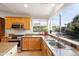 Bright kitchen with an island, stainless appliances, and a large window overlooking a lush yard at 3648 N 162Nd Ave, Goodyear, AZ 85395