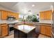 Well-lit kitchen with stainless steel appliances, an island, and a view of the backyard at 3648 N 162Nd Ave, Goodyear, AZ 85395