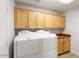 Functional laundry room with ample cabinet space and modern washer and dryer at 3648 N 162Nd Ave, Goodyear, AZ 85395