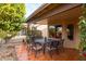 Covered patio with outdoor dining set perfect for entertaining guests at 3648 N 162Nd Ave, Goodyear, AZ 85395