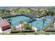 Aerial view showcasing multiple well-maintained pickleball courts surrounded by lush landscaping and palm trees at 3648 N 162Nd Ave, Goodyear, AZ 85395