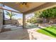 Covered patio overlooks a private backyard oasis with a freeform pool and lush landscaping at 3708 E Bruce Ave, Gilbert, AZ 85234