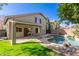 Expansive backyard with pool, covered patio, and lush green lawn at 3708 E Bruce Ave, Gilbert, AZ 85234