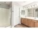 Bathroom featuring double sinks, a shower with glass door, and neutral paint at 3708 E Bruce Ave, Gilbert, AZ 85234