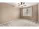 Carpeted bedroom with ceiling fan and window allowing ample natural light at 3708 E Bruce Ave, Gilbert, AZ 85234