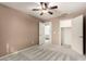 Bedroom with carpet, neutral color and a ceiling fan; closet access is nearby at 3708 E Bruce Ave, Gilbert, AZ 85234