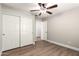 Bedroom with wood floors, closet, and ceiling fan at 3708 E Bruce Ave, Gilbert, AZ 85234