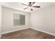 Bedroom with wood floors, large window, and ceiling fan at 3708 E Bruce Ave, Gilbert, AZ 85234