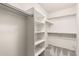 Walk-in closet with shelving, hanging rods, and neutral paint at 3708 E Bruce Ave, Gilbert, AZ 85234