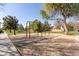 Neighborhood playground featuring swings, a sandbox, and mature trees at 3708 E Bruce Ave, Gilbert, AZ 85234